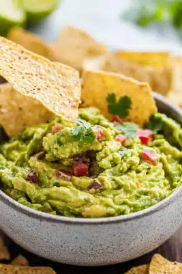 Spicy Guacamole recipe with Sriracha and fresh ingredients. Elevate your snack game with this zesty dip. Try it today!

